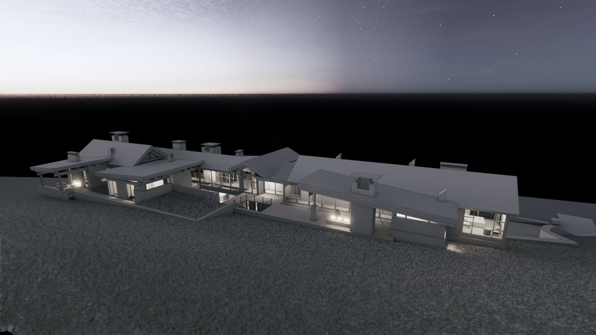 An aerial view of a large house with a lot of windows at night.