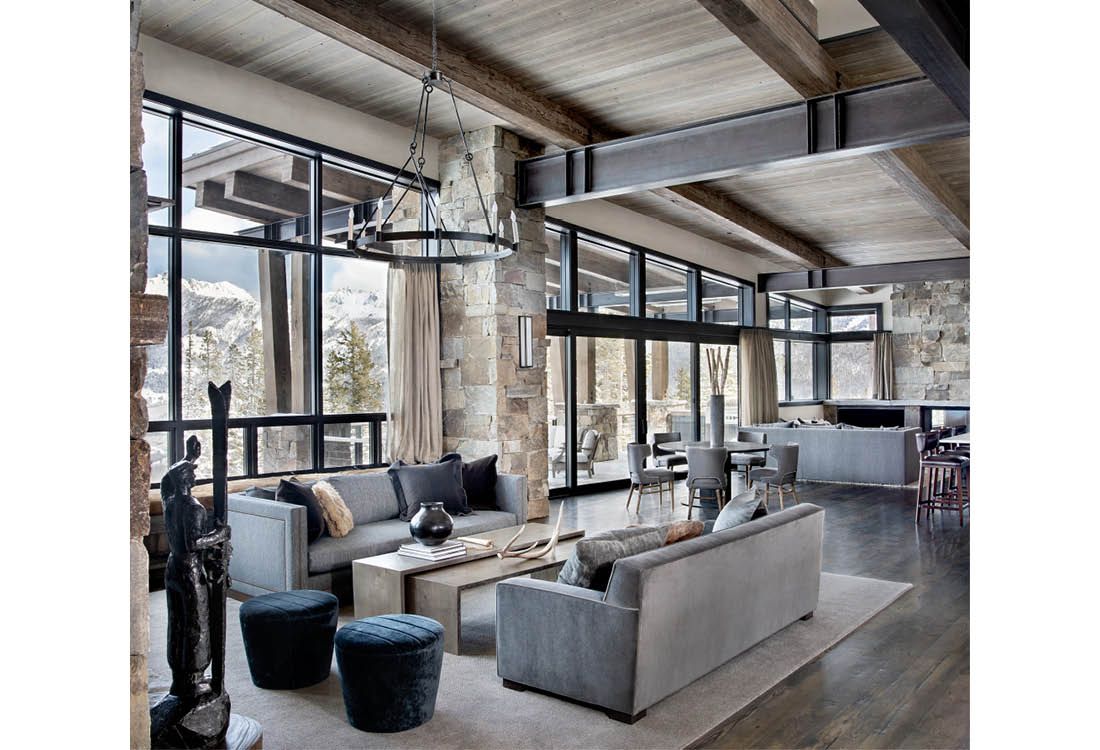 A living room with a lot of furniture and a lot of windows.