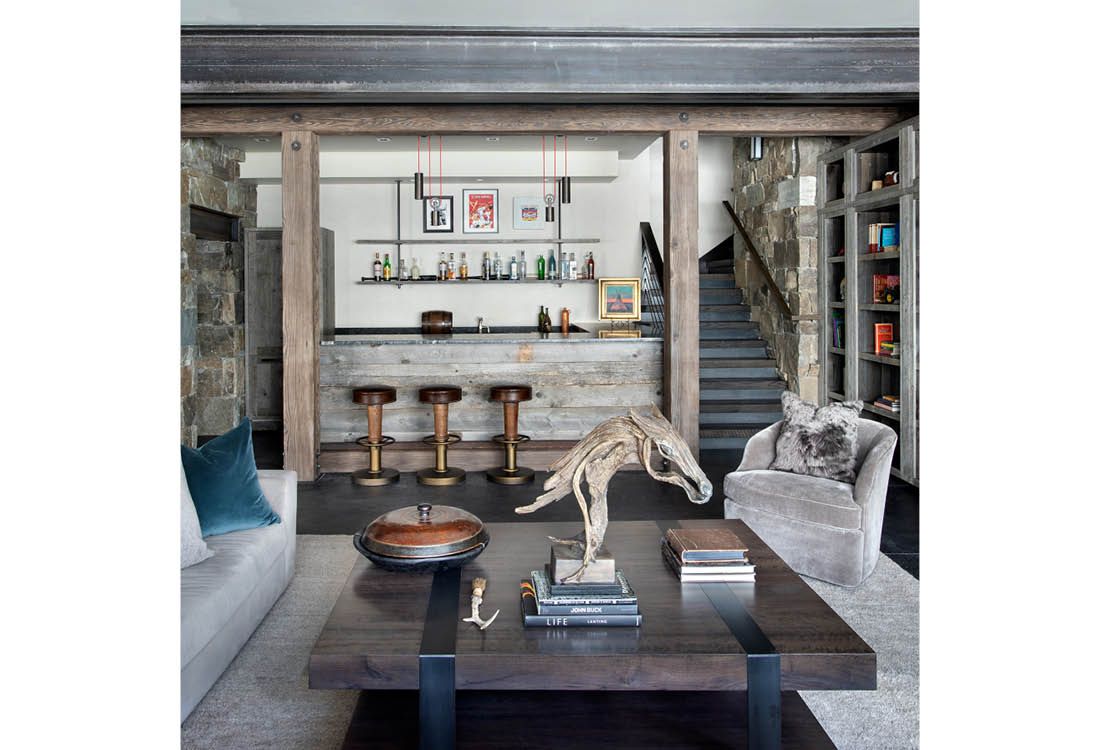 A living room with a coffee table and a statue of a dinosaur on top of it.