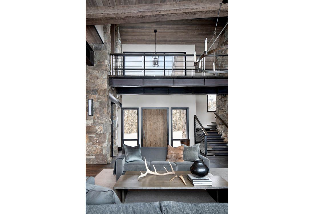 A living room with a couch , coffee table , and stairs.