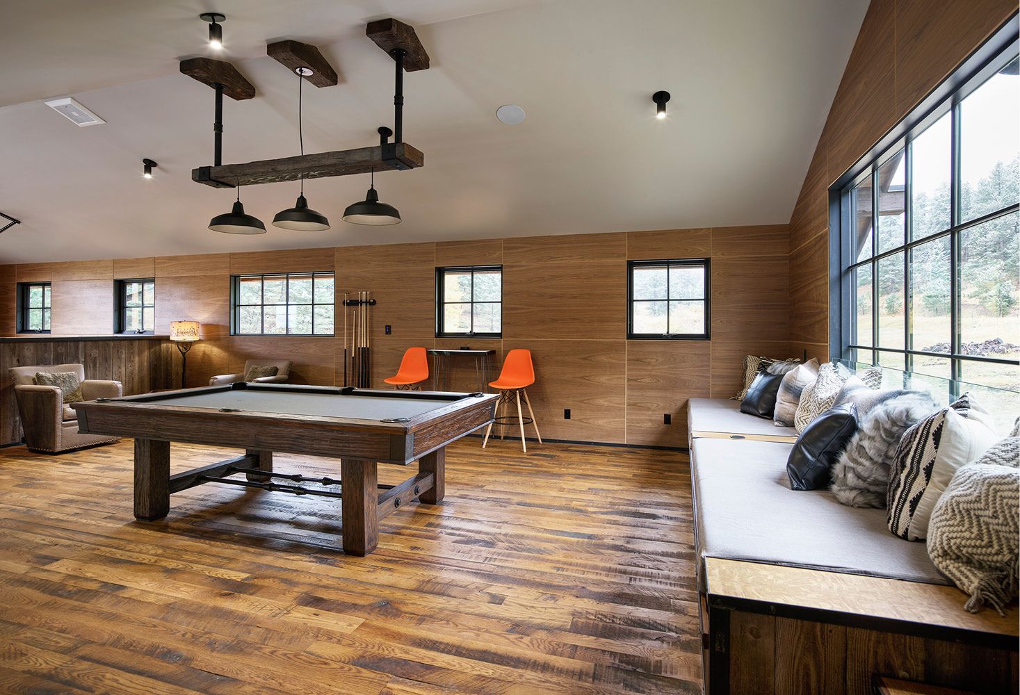 There is a pool table in the middle of the room.