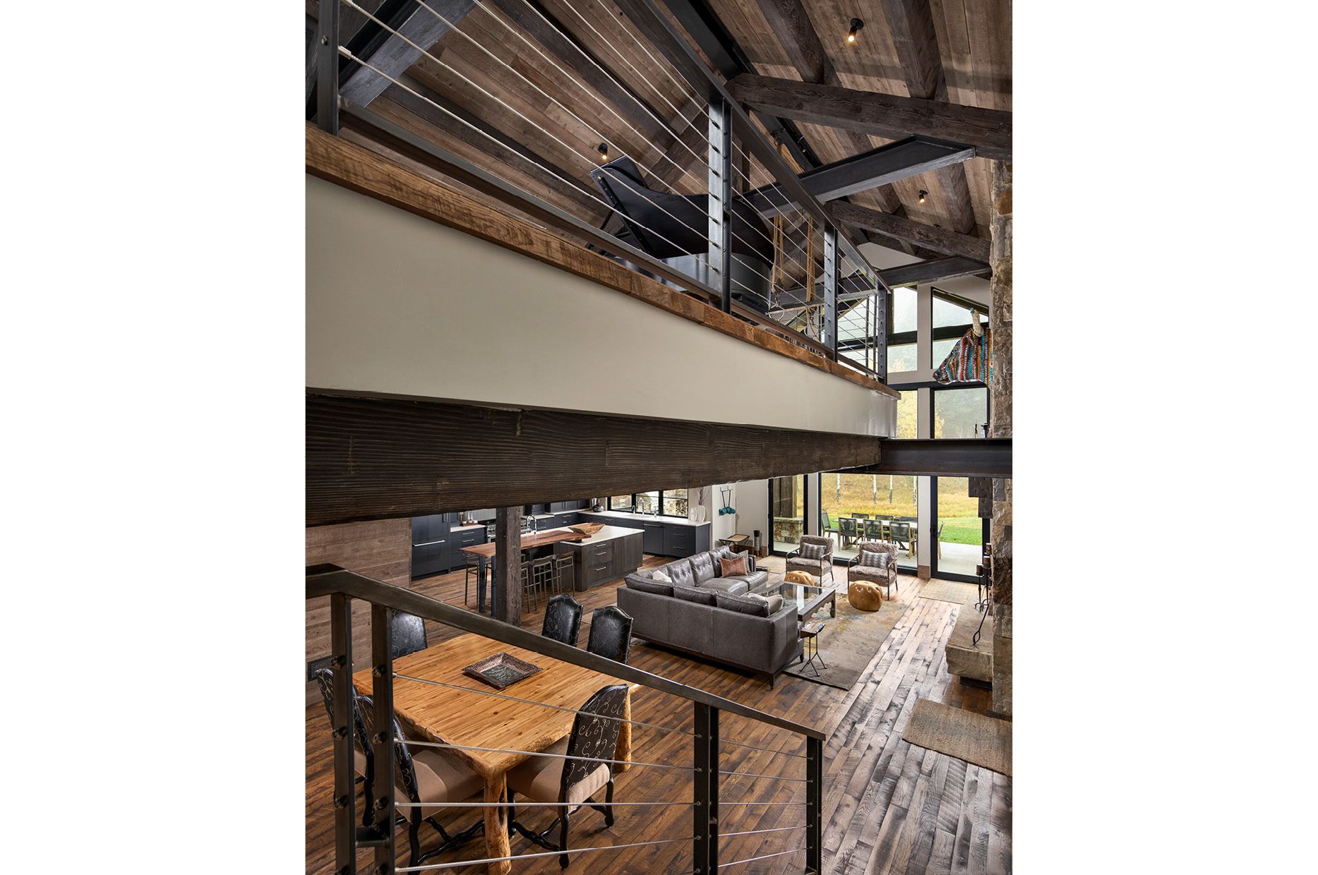 A living room with a couch , table , chairs and a balcony.