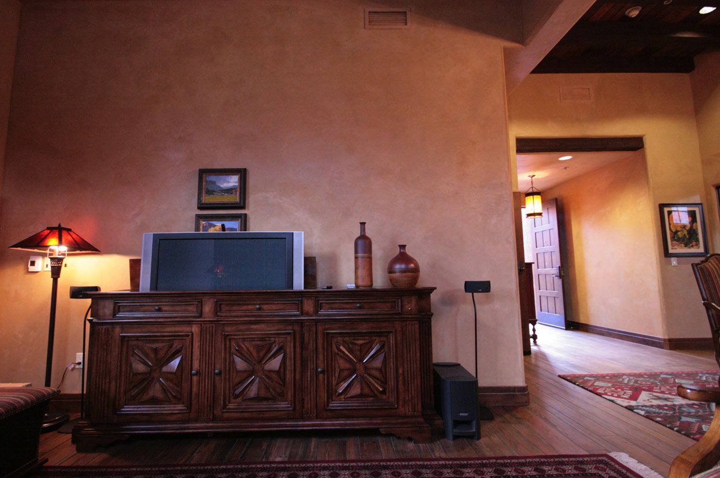 A living room with a tv on top of a dresser