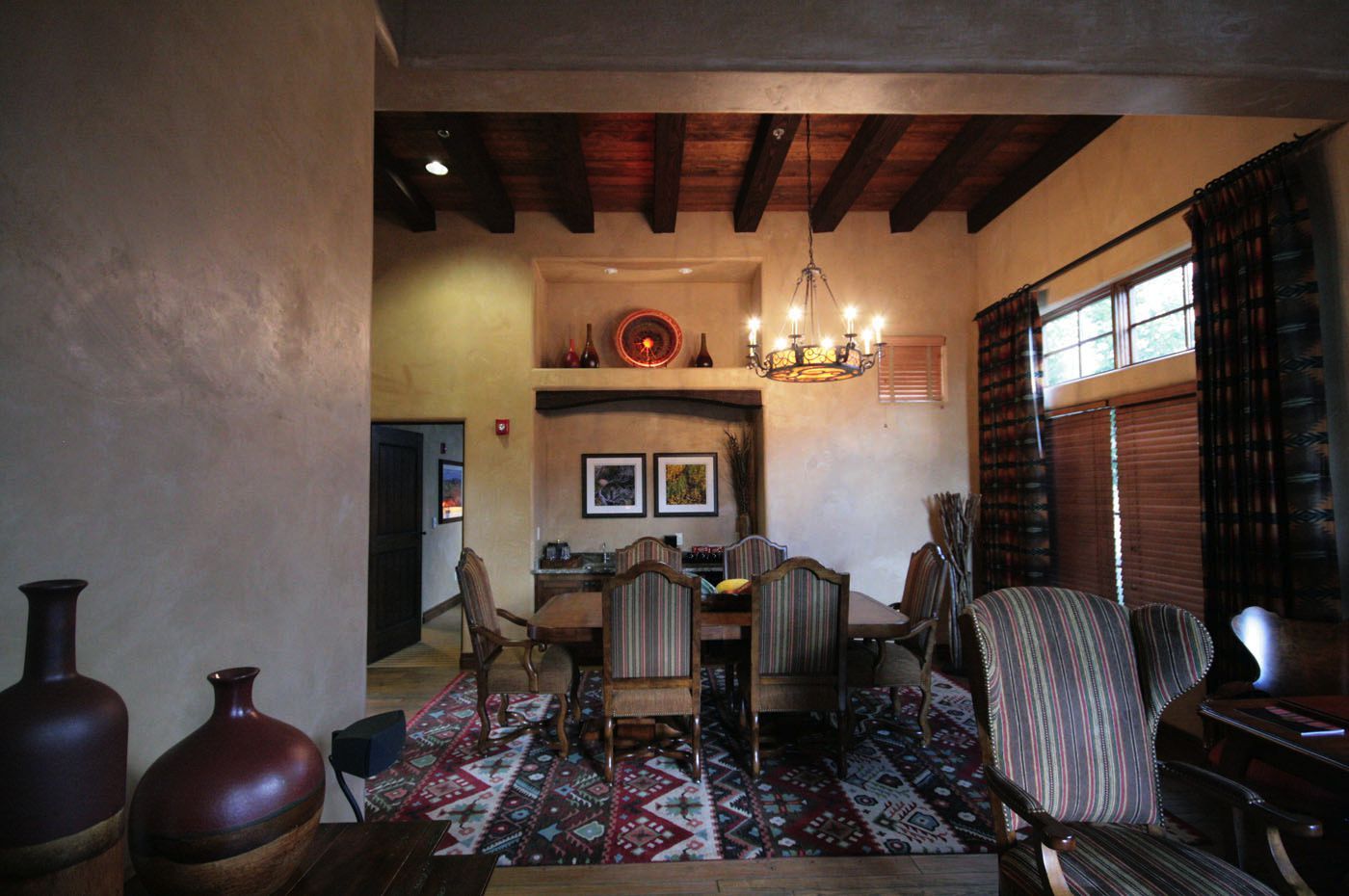 A dining room with a table and chairs and a chandelier