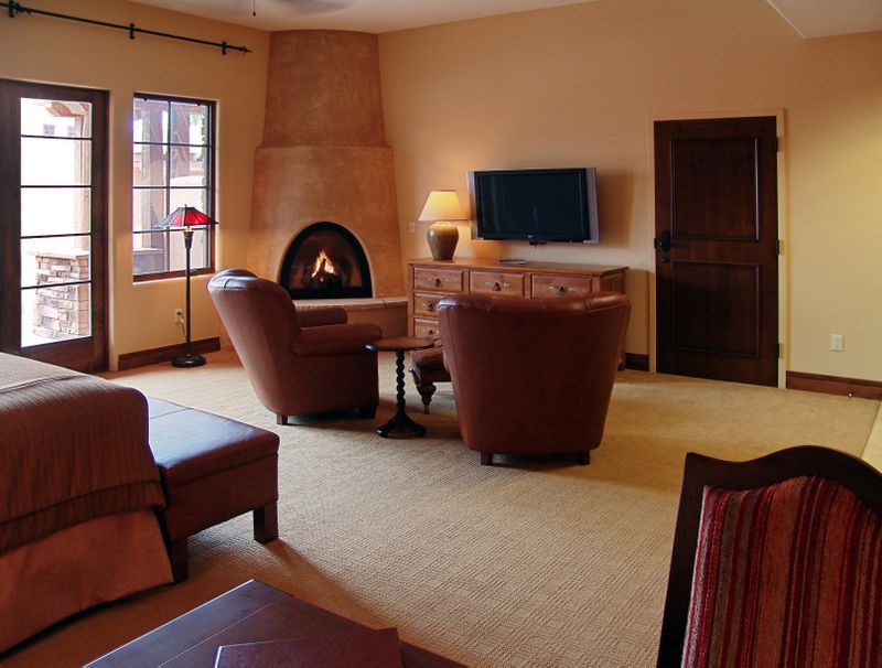 A living room with a fireplace and a flat screen tv
