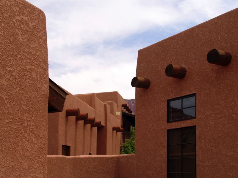 A row of adobe buildings with a black door