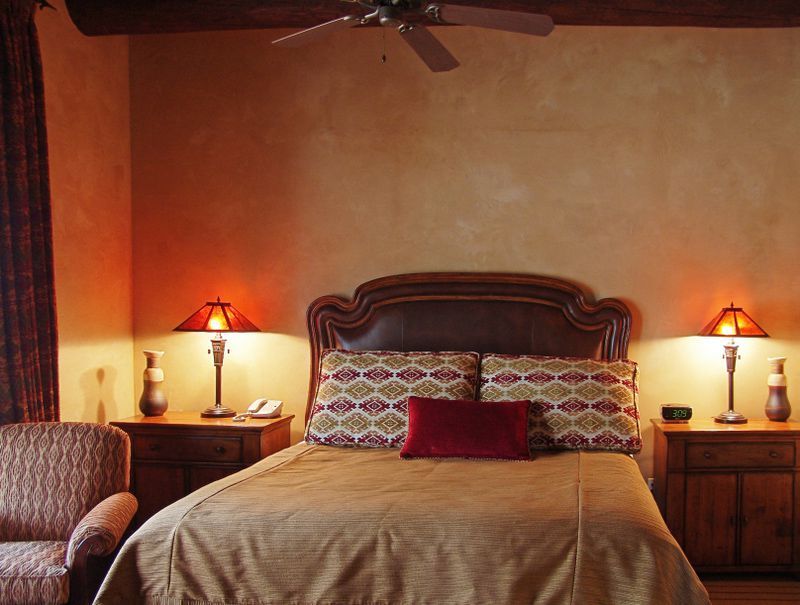 A bedroom with a large bed and two lamps