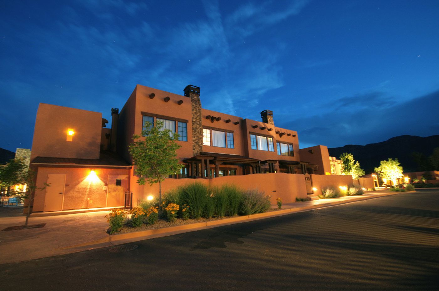 A building with a lot of windows is lit up at night