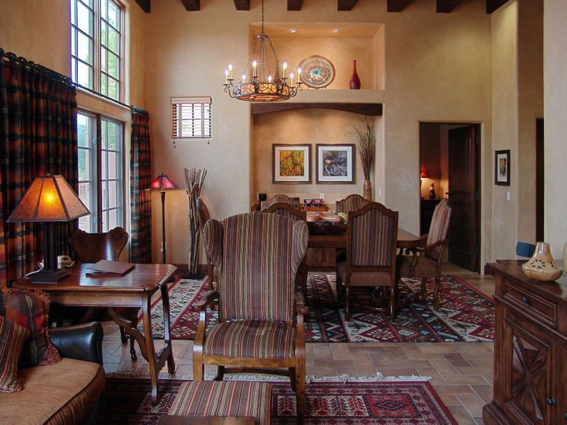 A living room with a dining room table and chairs
