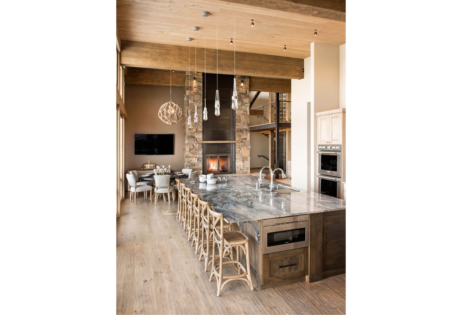 A kitchen with a large island and a fireplace.