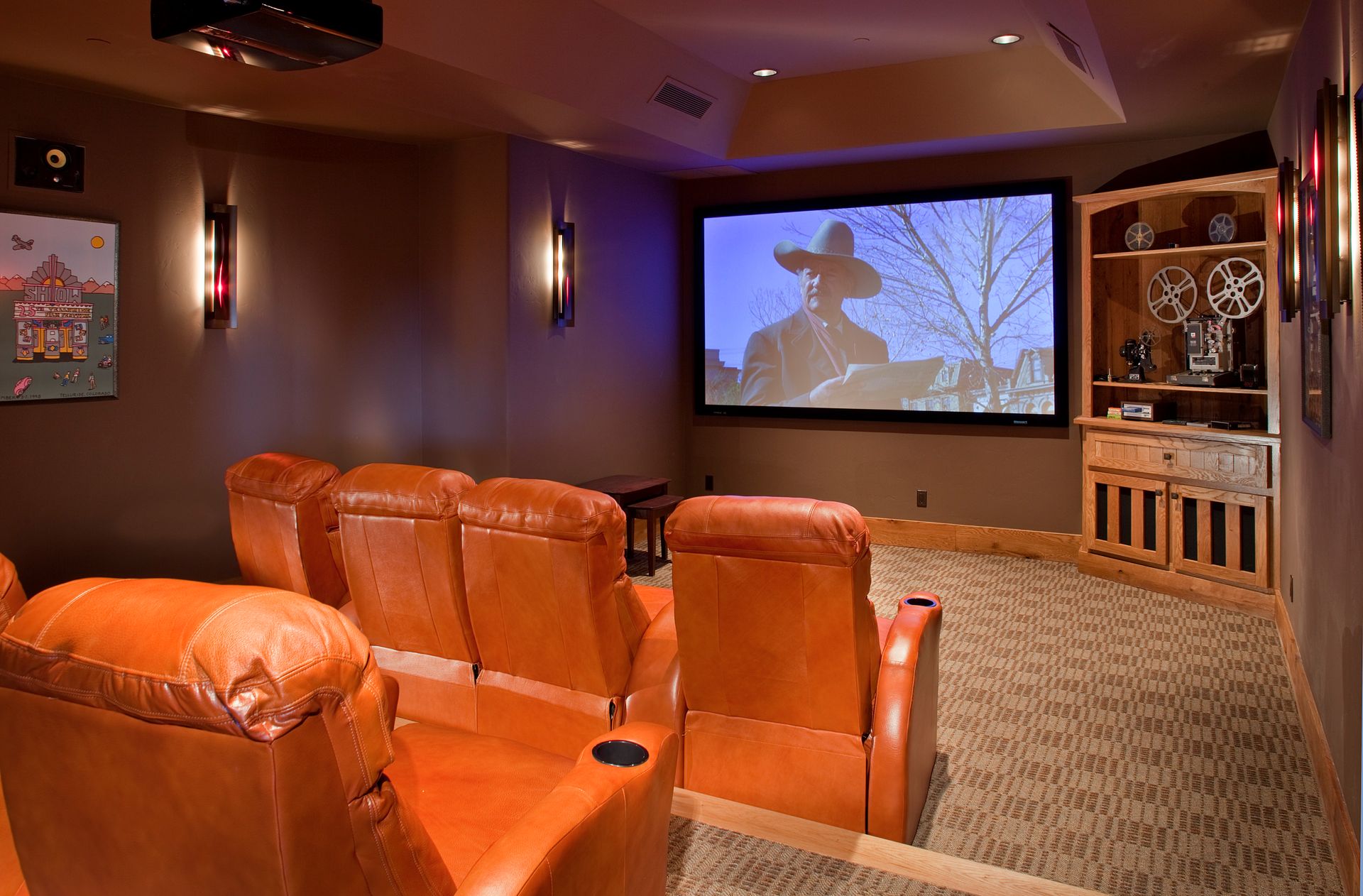 A home theater with a cowboy on the screen