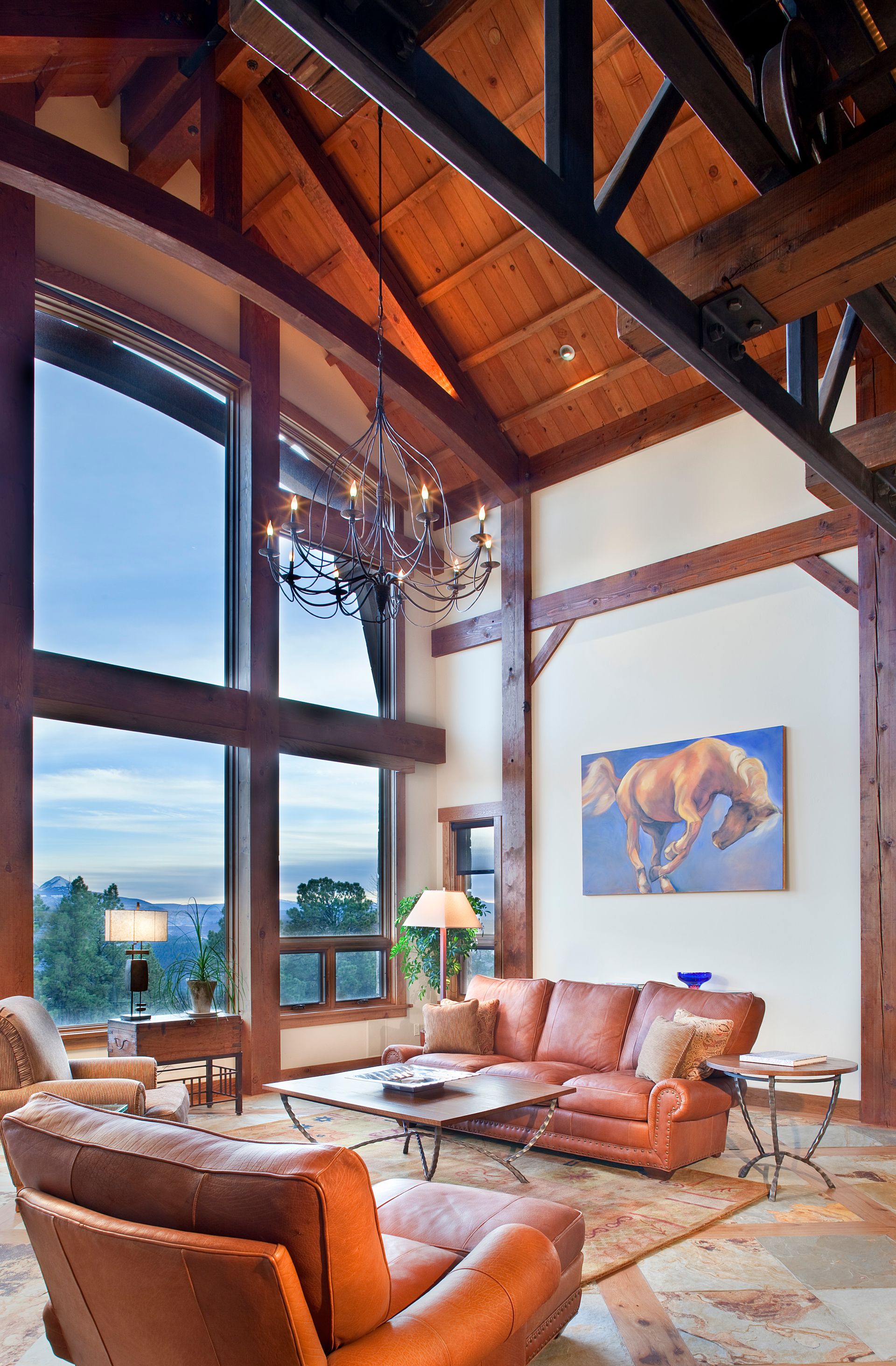 A living room with a horse painting on the wall