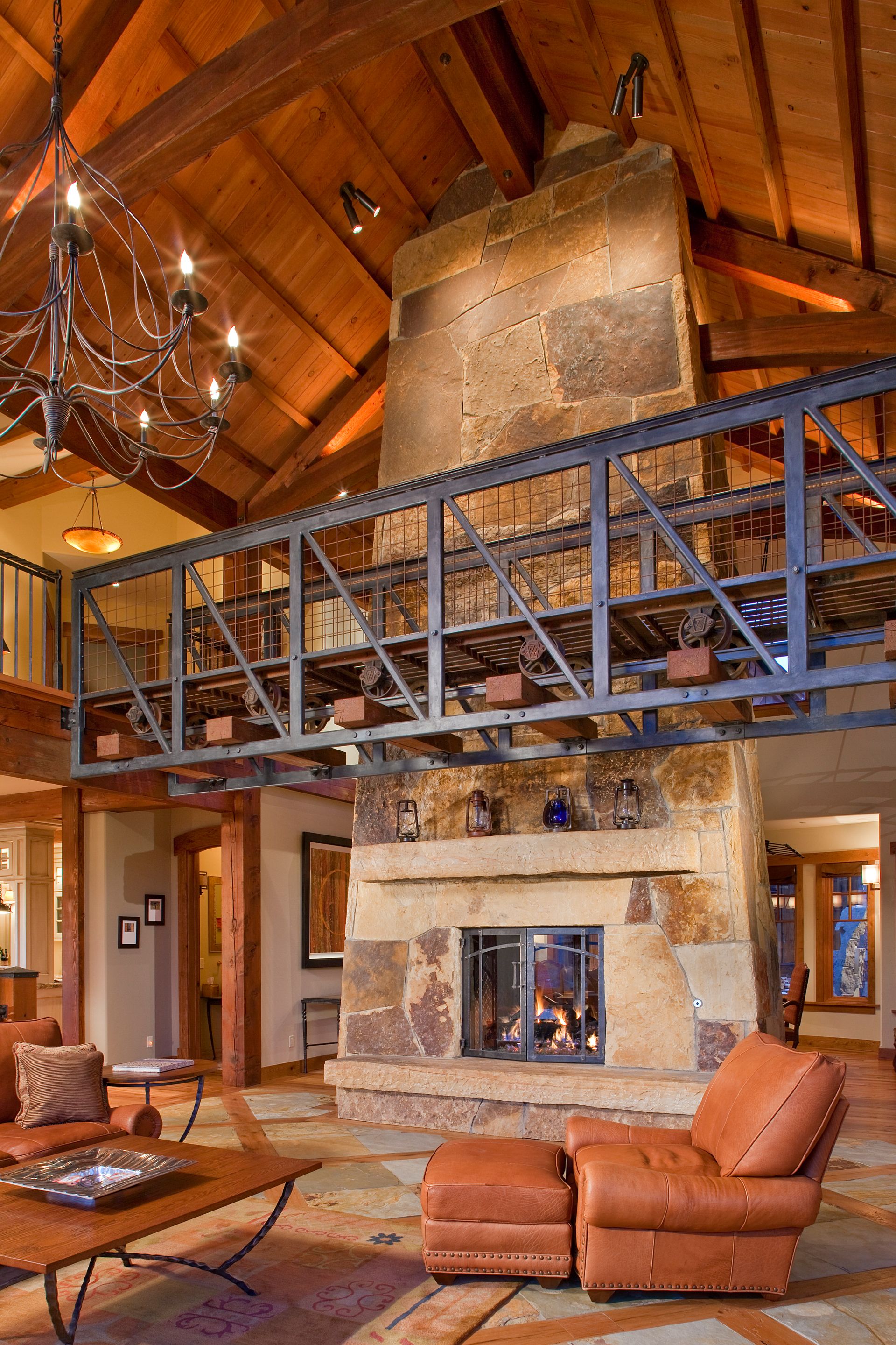 A living room with a fireplace and a chandelier