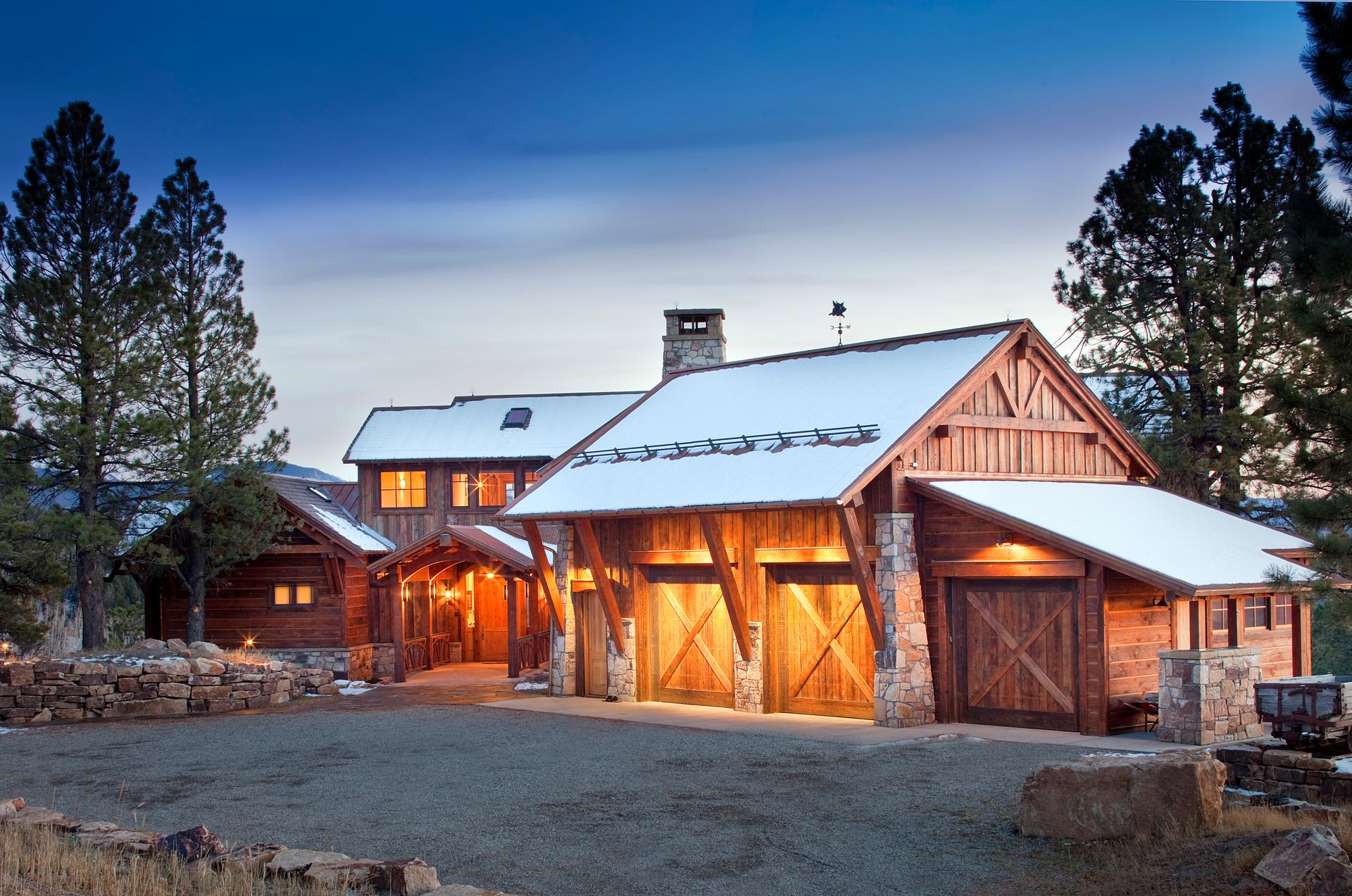 A large log cabin with snow on the roof