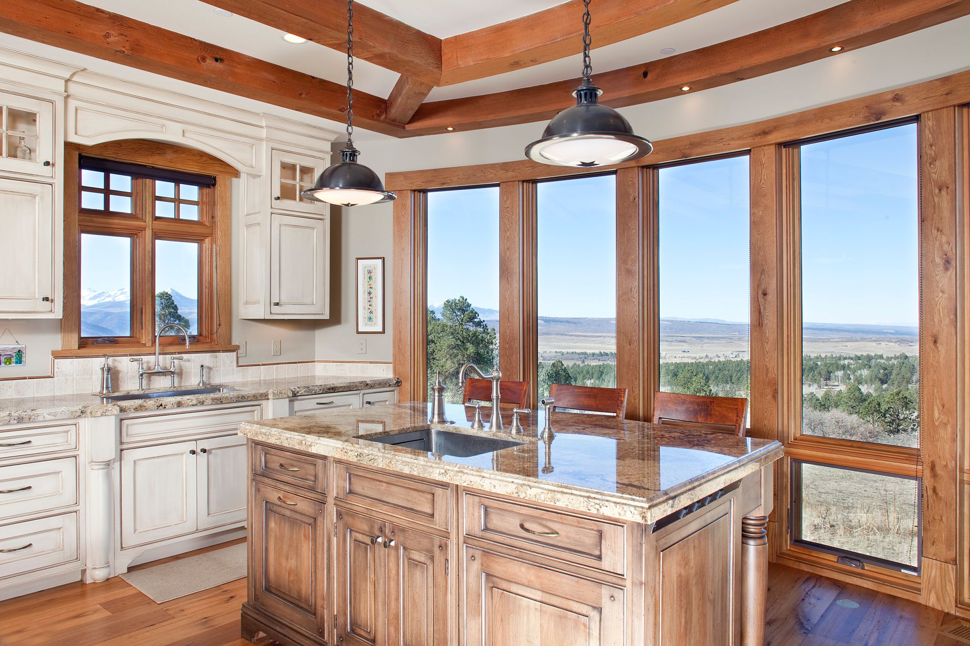 A kitchen with a large island and lots of windows