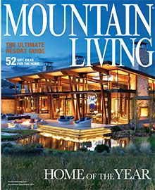 A mountain living magazine cover with a large house on it.