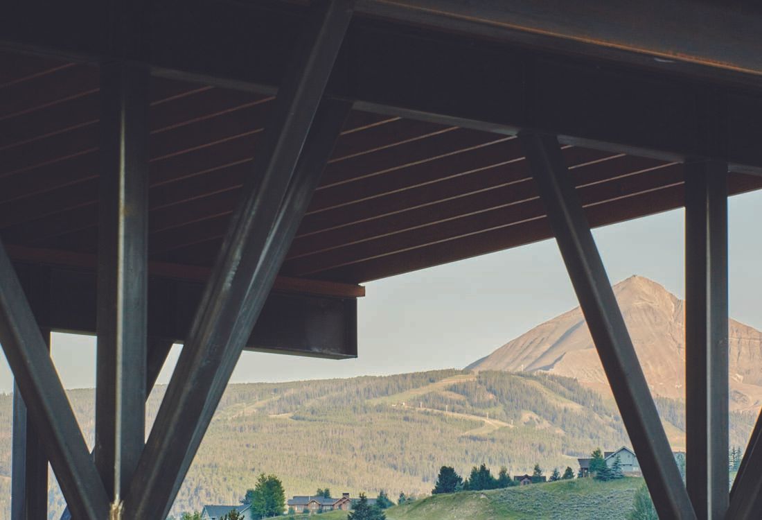 A bridge with a view of mountains and trees
