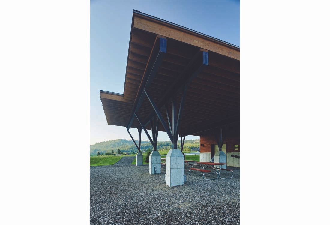 A large wooden structure with a roof and pillars