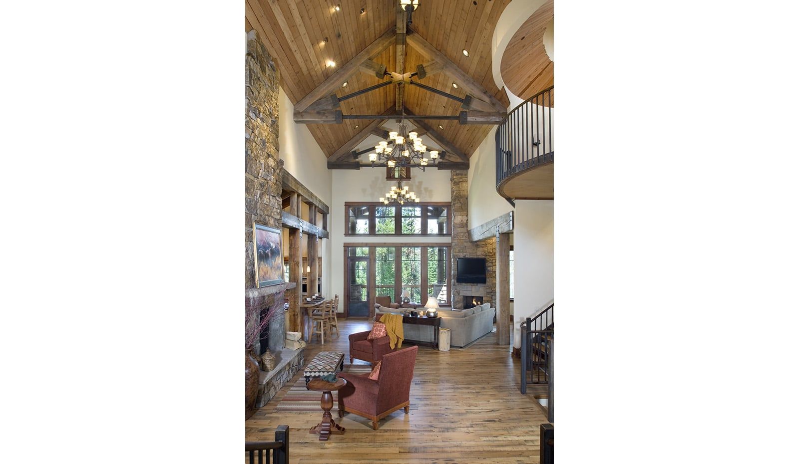 A living room with a wooden ceiling and a red chair