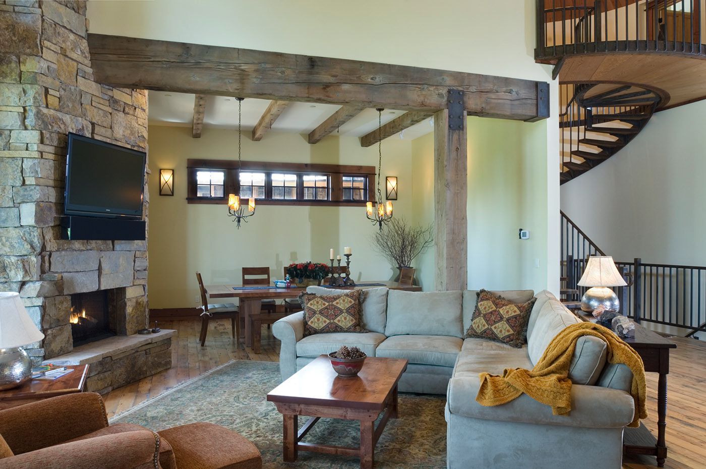 A living room with a sectional couch and a fireplace