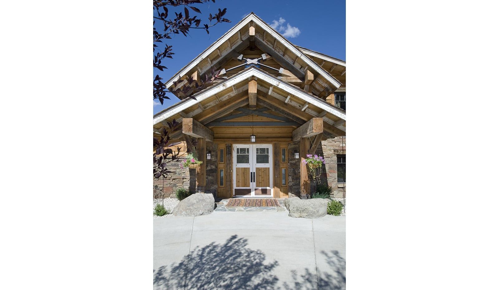 A large wooden house with a balcony and a white door