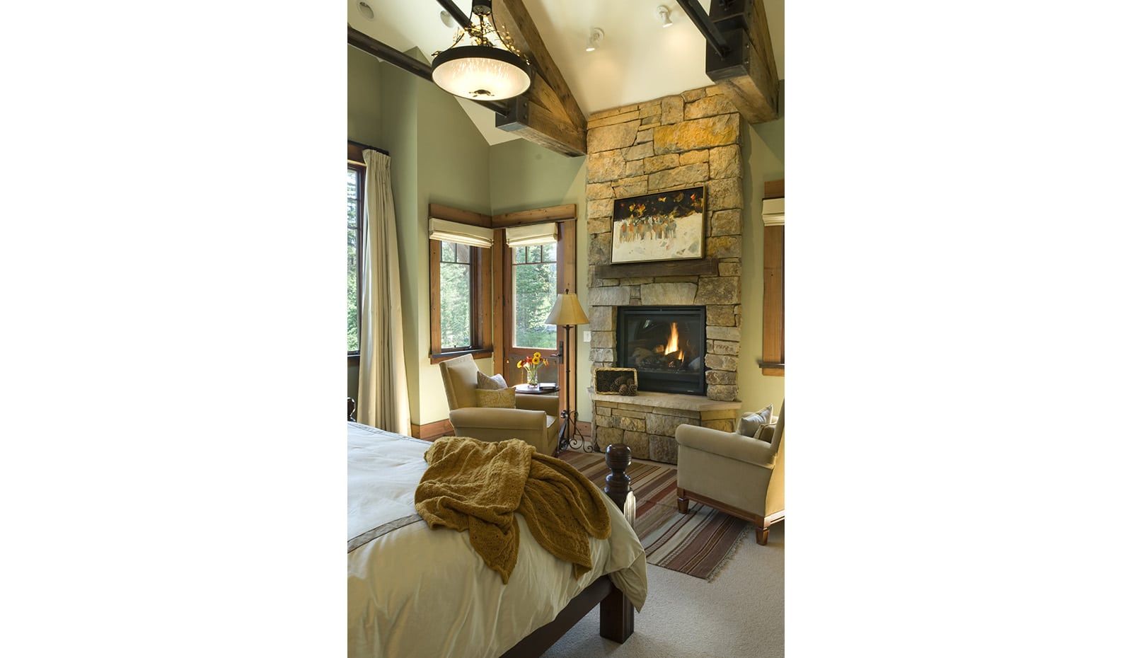 A bedroom with a fireplace and a bed