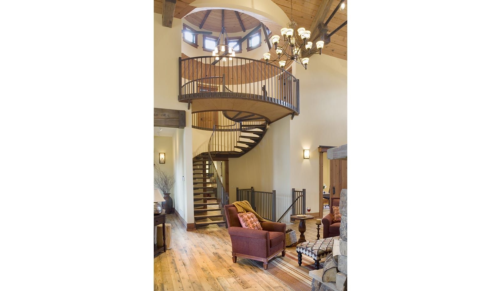 A living room with a spiral staircase and a chandelier