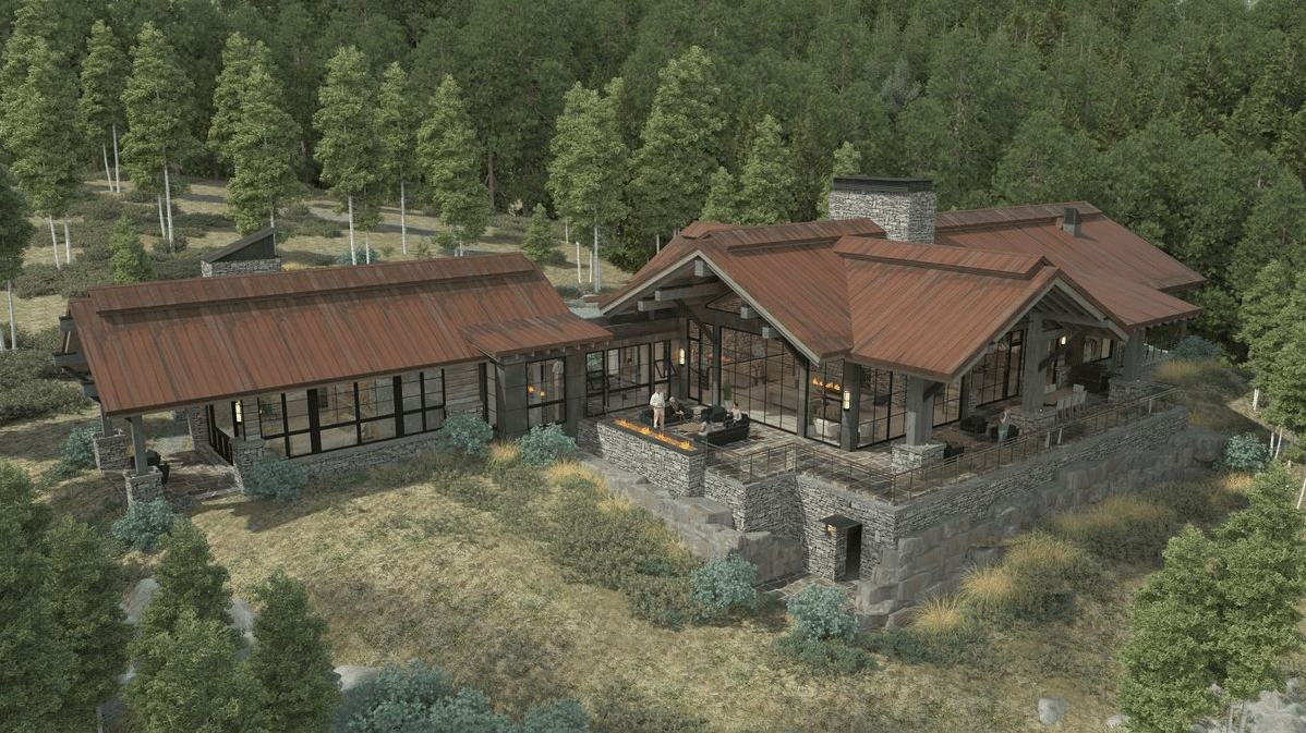 An aerial view of a large house in the middle of a forest.