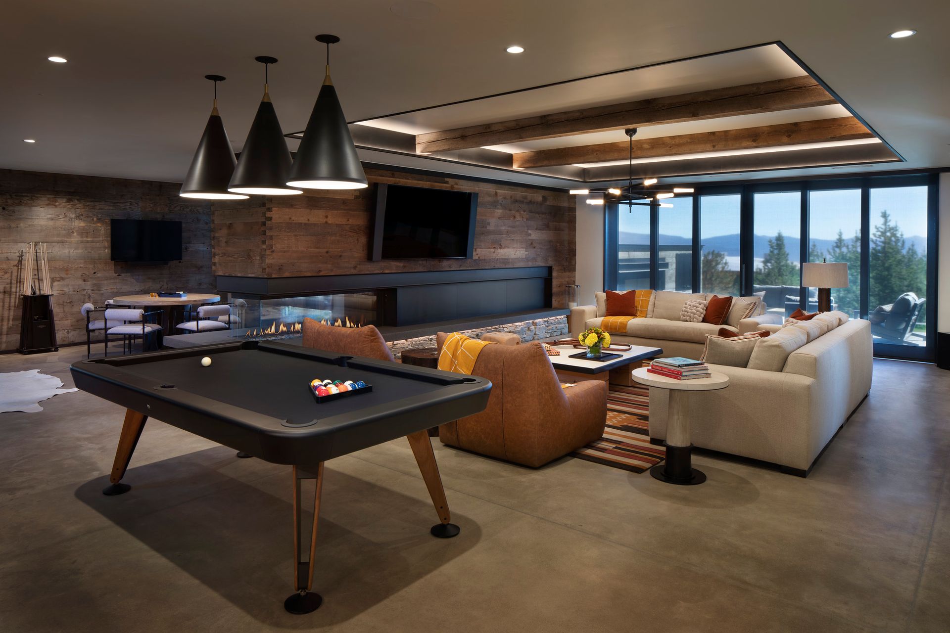 There is a pool table in the middle of the living room.