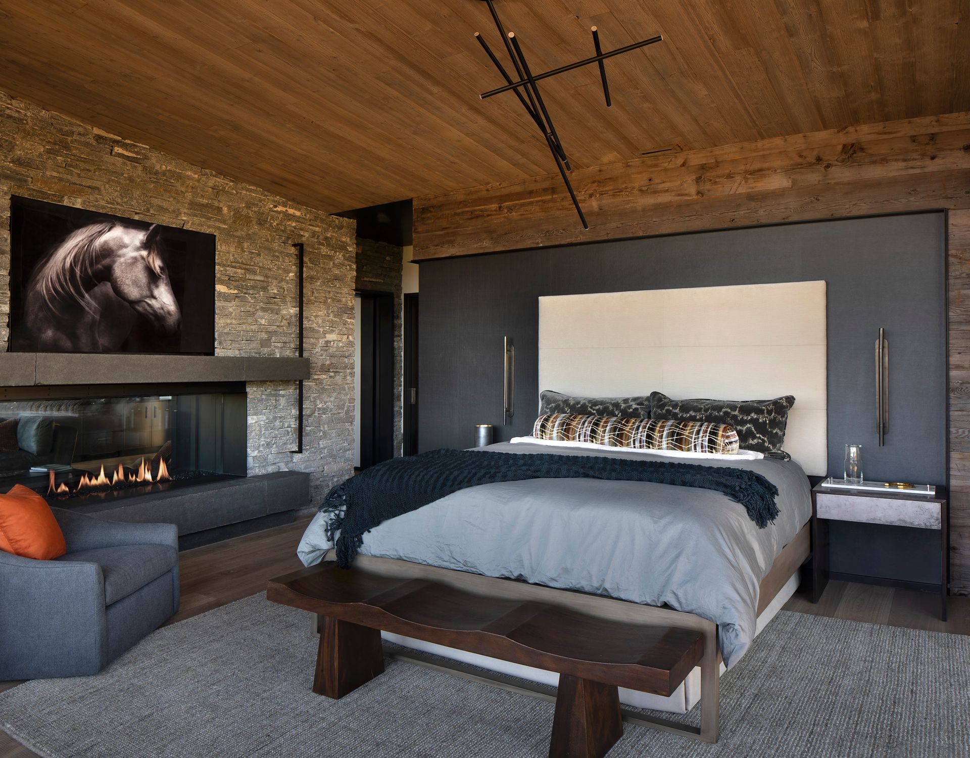 A bedroom with a large bed and a fireplace