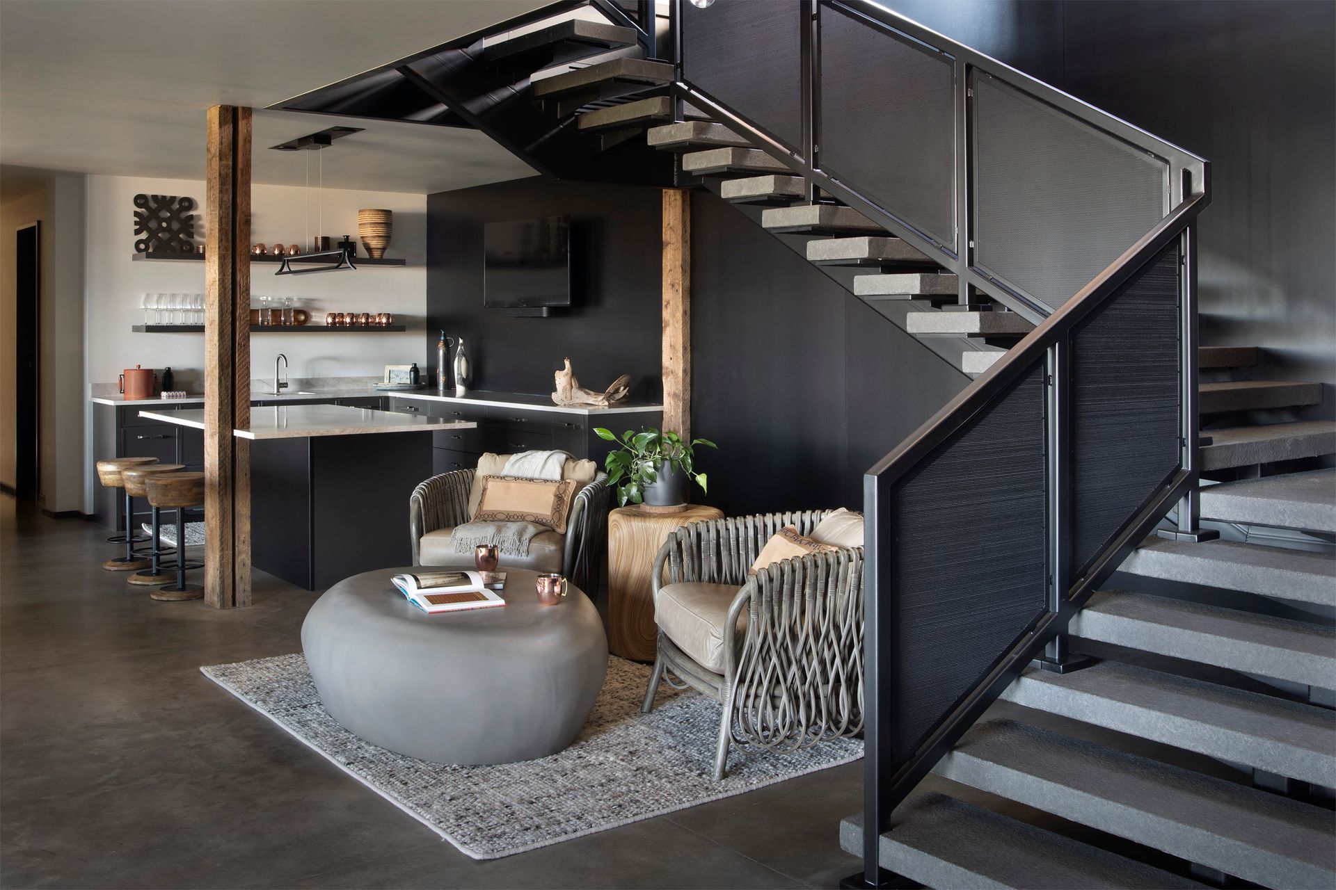 A living room with a staircase leading up to the second floor