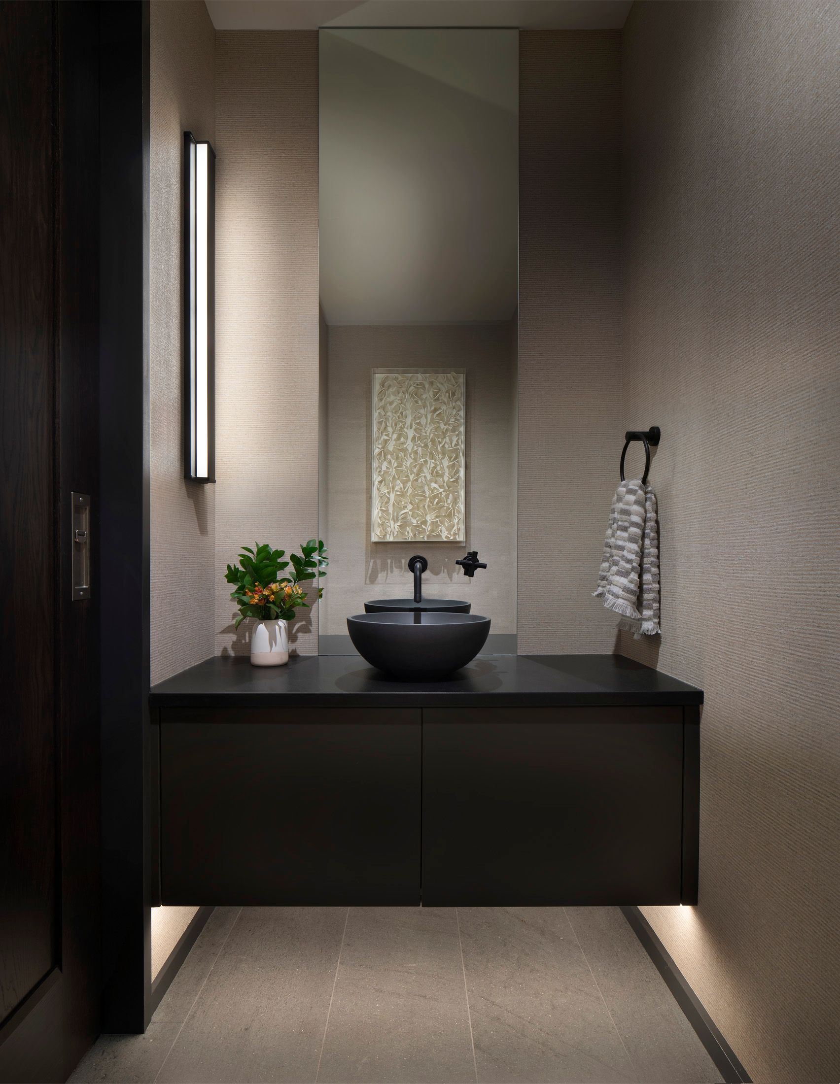 A bathroom with a sink , mirror and towel rack.