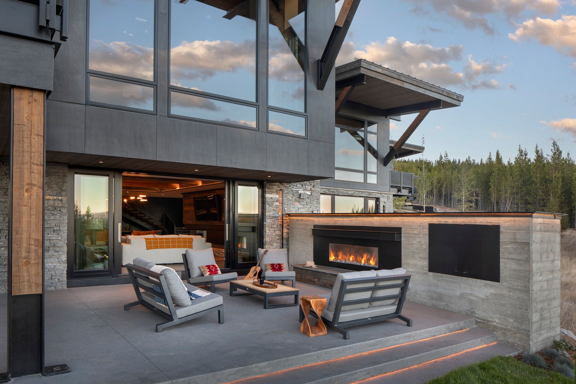 There is a fireplace in the backyard of a house.