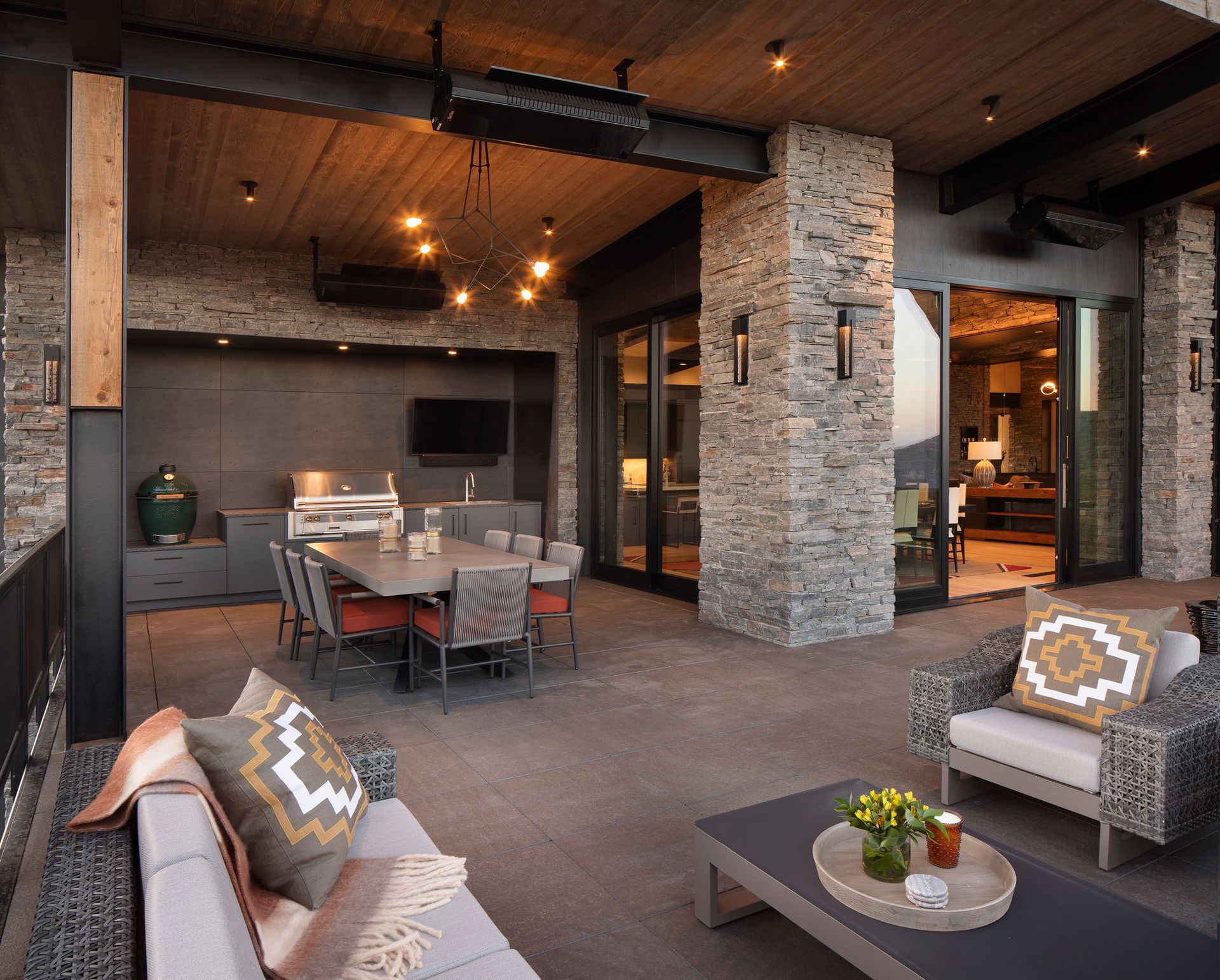 A patio with a couch and chairs and a table and chairs