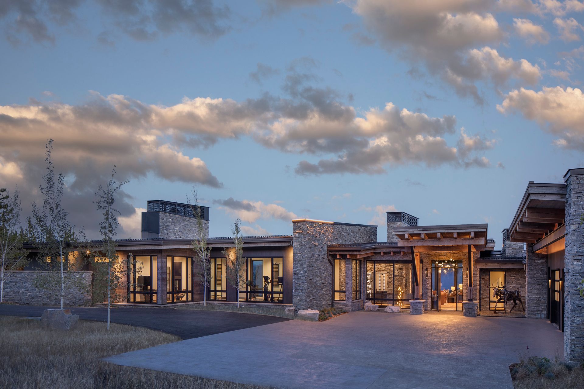 A large house with a lot of windows is lit up at night