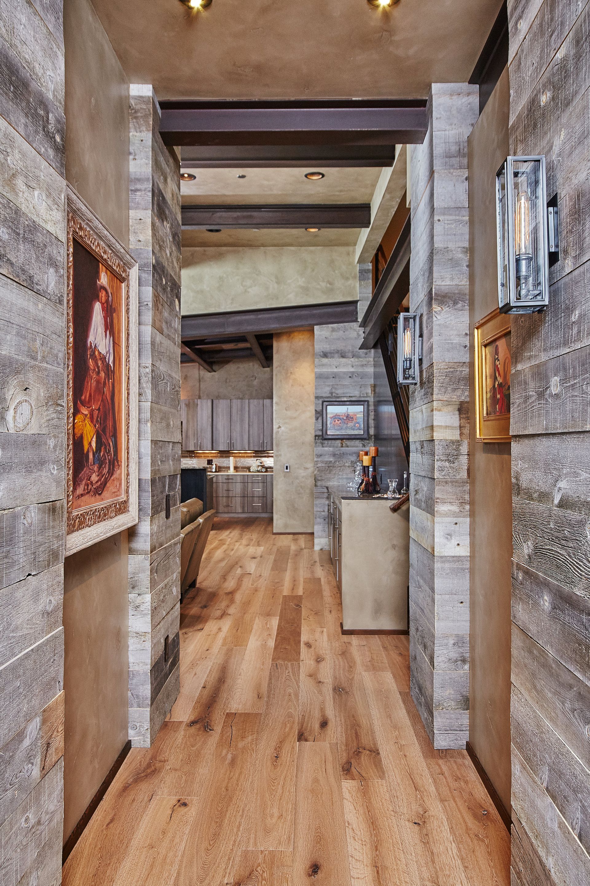 A hallway with wooden floors and a painting on the wall
