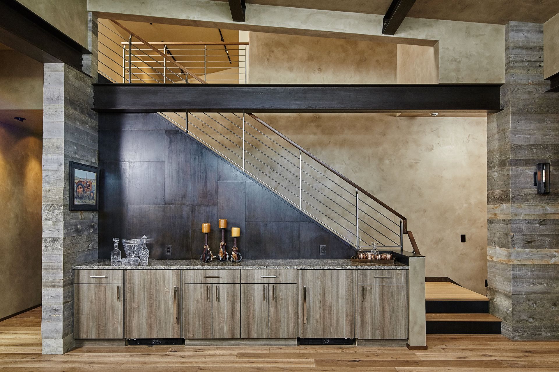 A staircase in a house with a bar underneath it