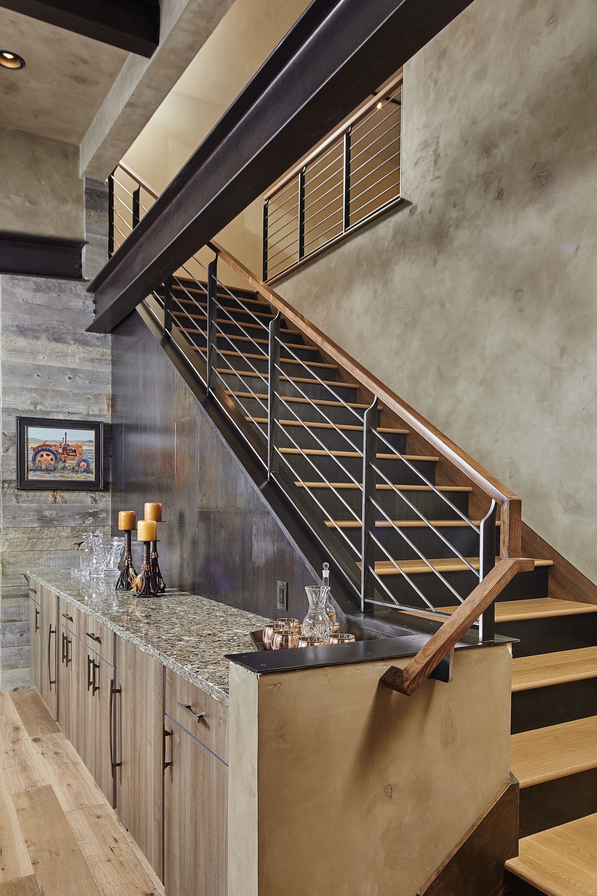 A staircase with a metal railing and wooden steps in a kitchen