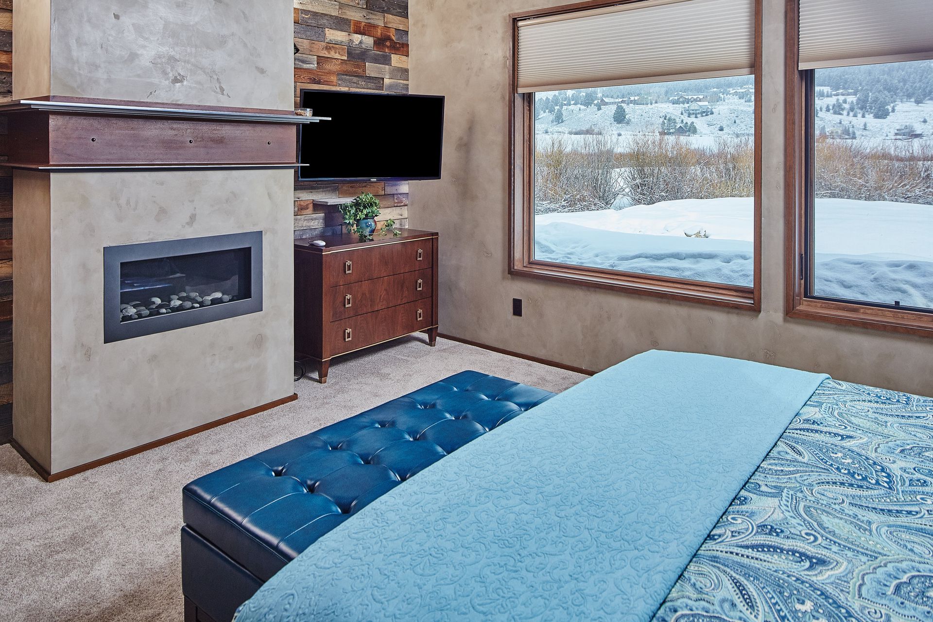 A bedroom with a bed , fireplace and television
