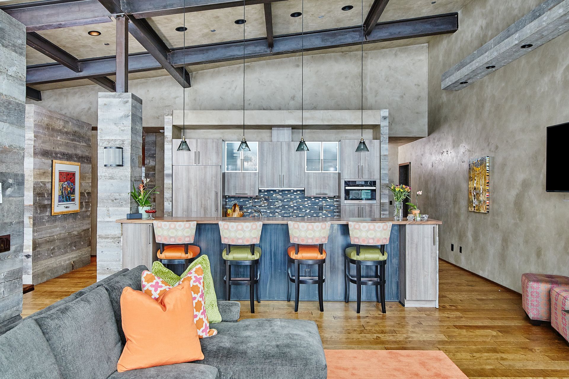 A living room with a couch and a kitchen in the background.