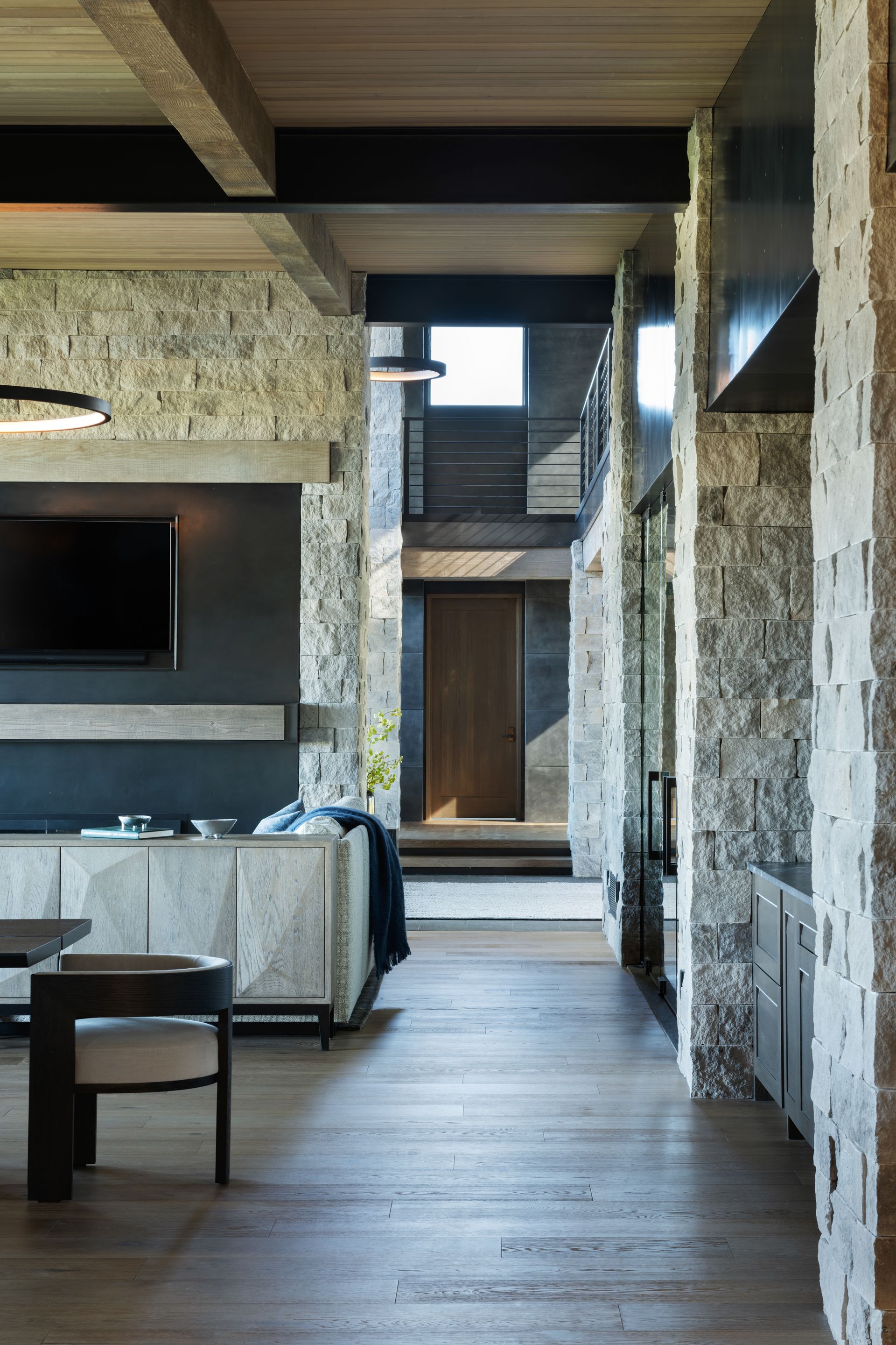 A living room with a couch , table , chairs and a television.