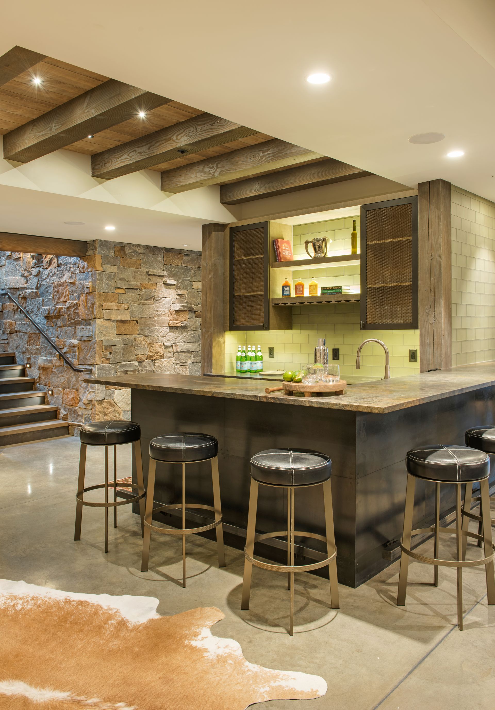 A kitchen with a large island and stools