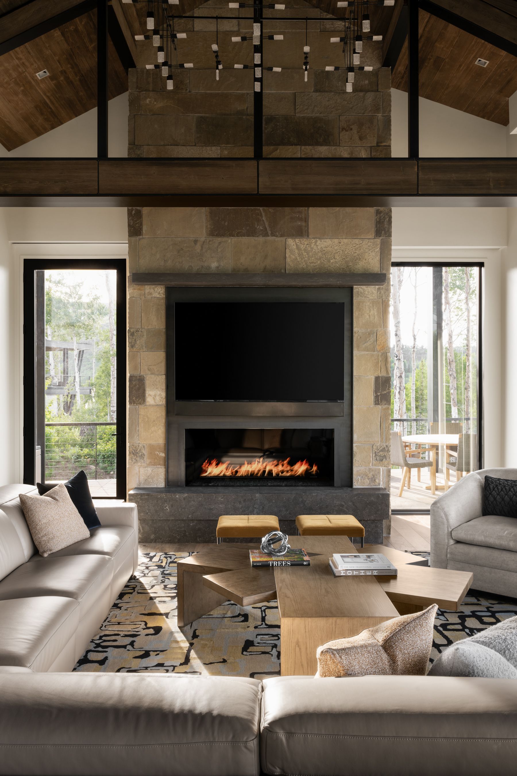A living room with a fireplace and a flat screen tv on the wall.