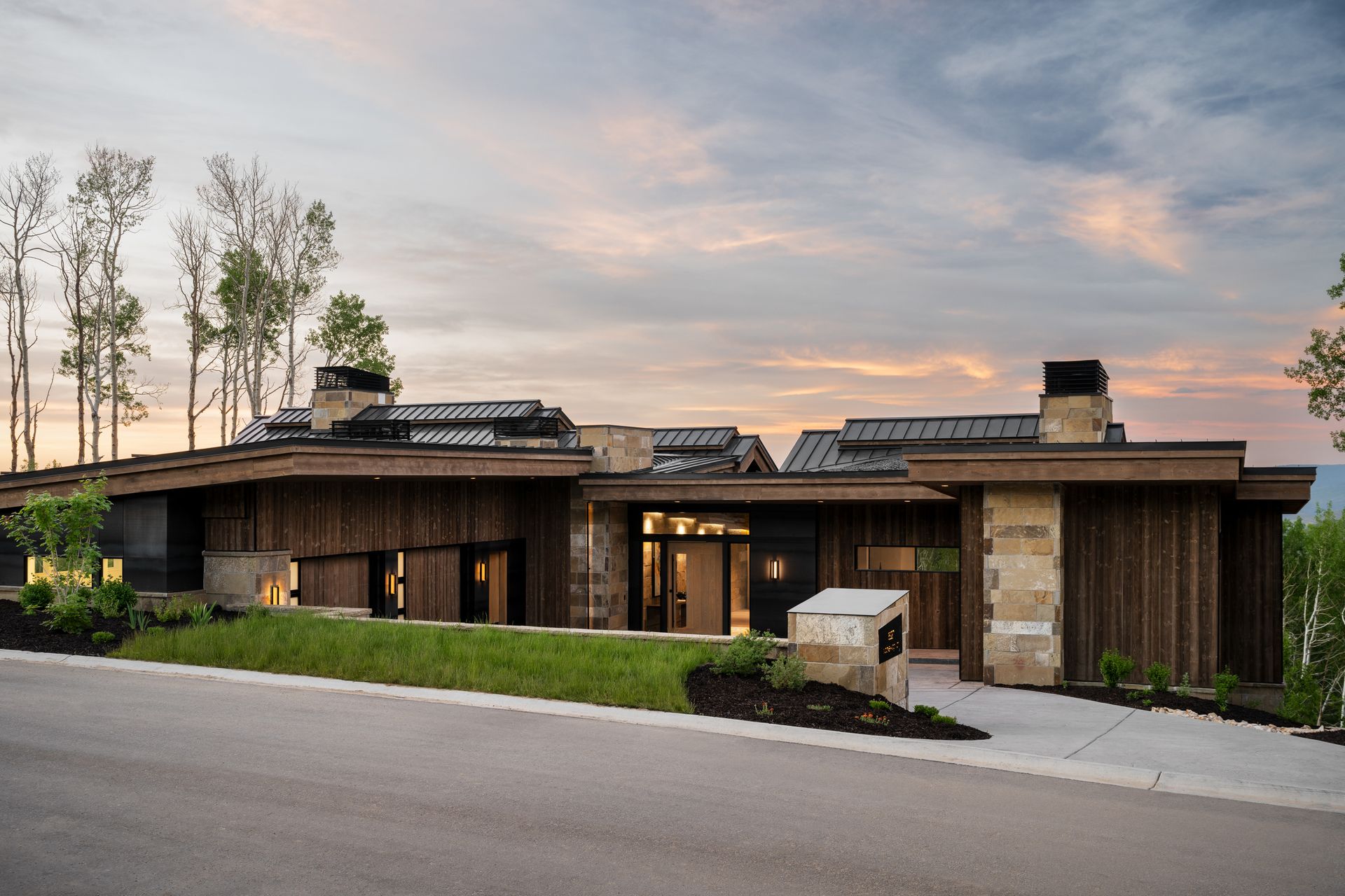 A large house with a lot of windows is sitting on top of a hill.