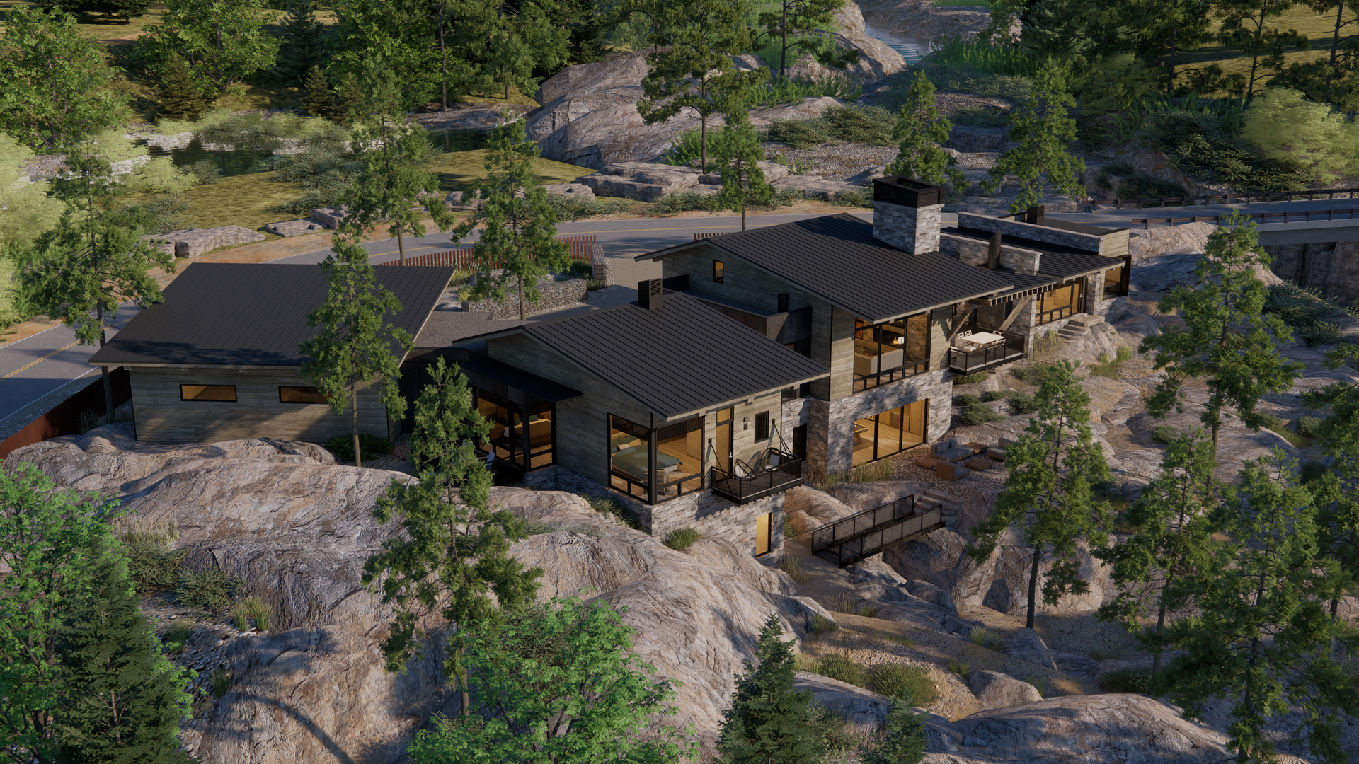 An aerial view of a large house on top of a rocky hill surrounded by trees.