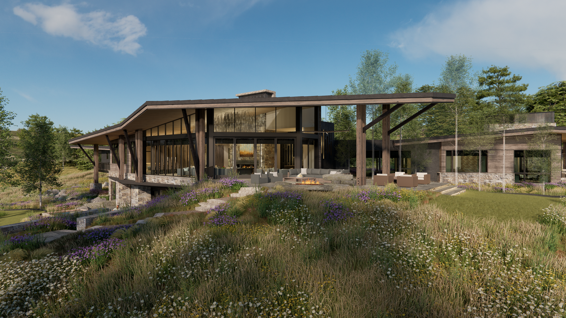 A large house is sitting in the middle of a field surrounded by trees.