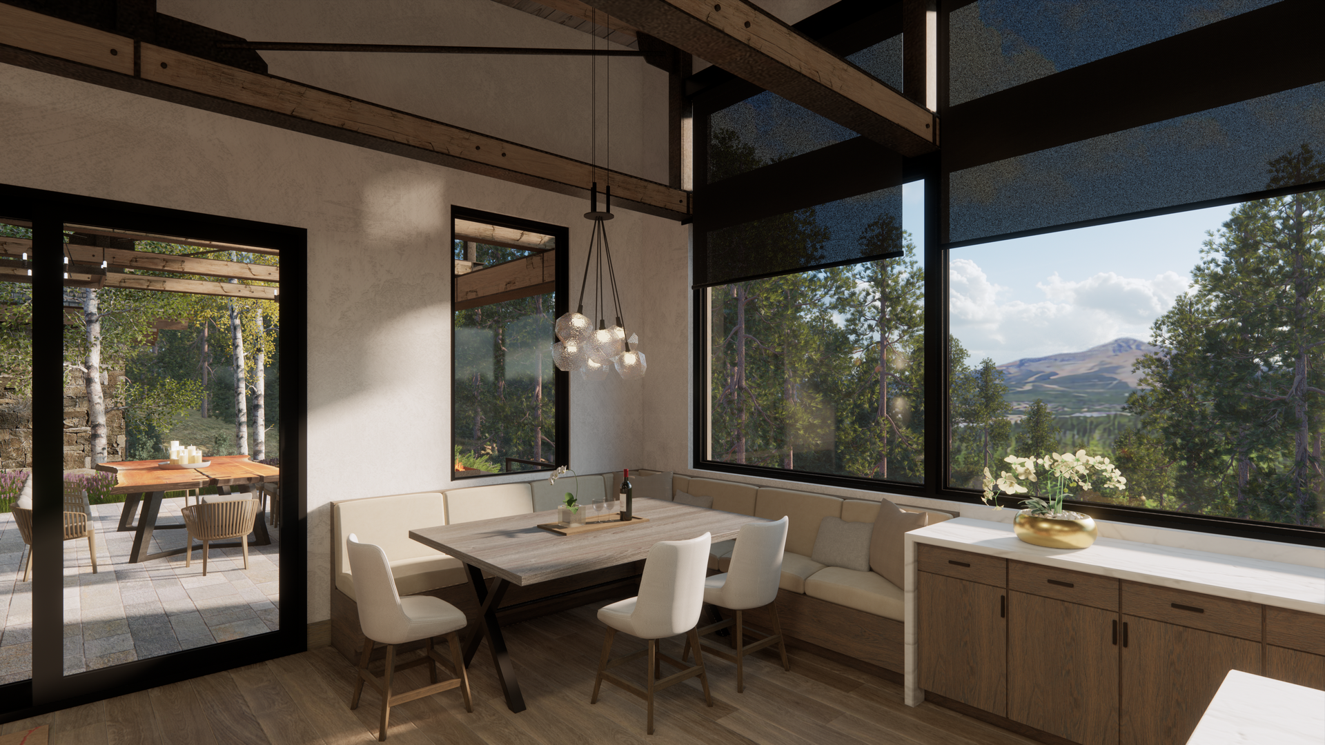 A dining room with a table and chairs and a view of the mountains.