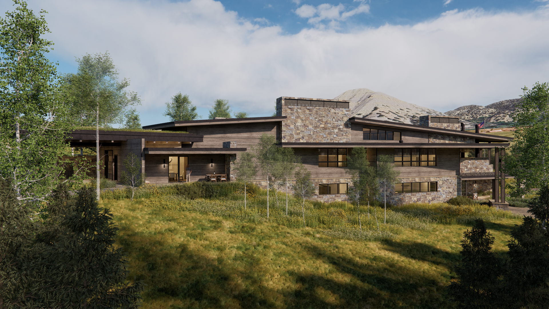 A large house is sitting on top of a grassy hill surrounded by trees.