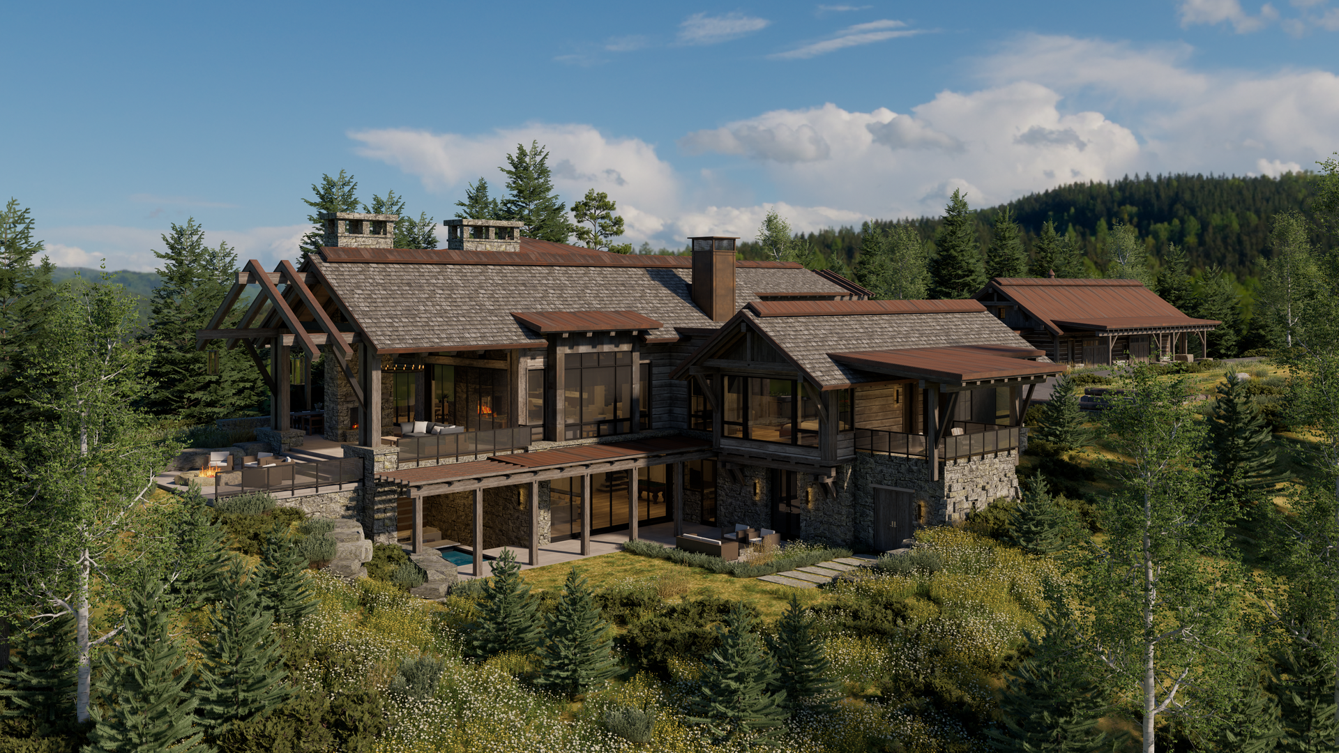 A large house is sitting on top of a hill in the middle of a forest.