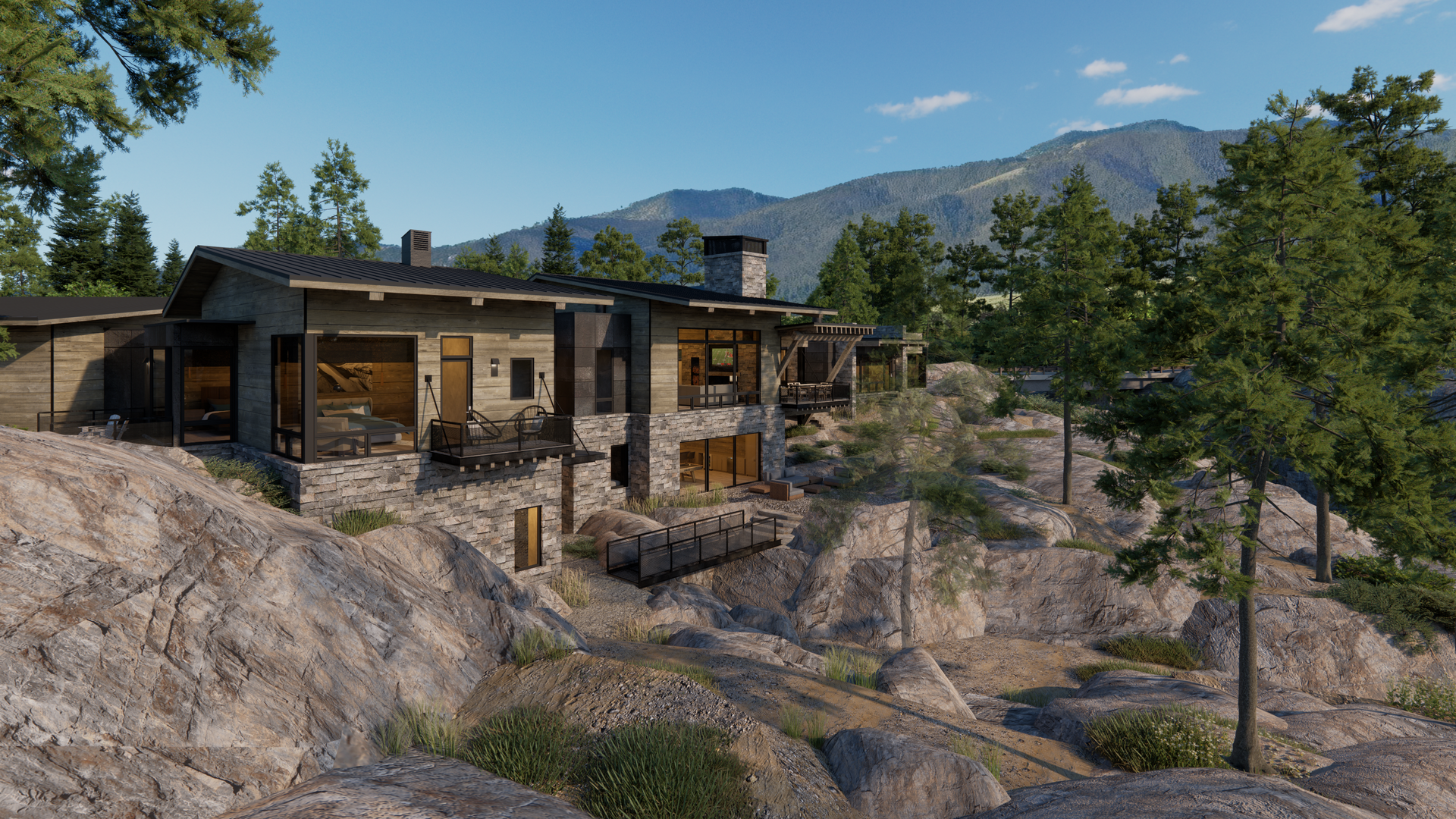 A house is sitting on top of a rocky hill with mountains in the background.